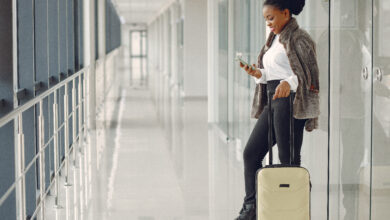 black woman with suitcase at the airport