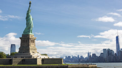 statue of liberty and the new york city skyline usa
