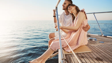 happy beautiful adult couple sitting on side of yacht watching at seaside and hugging while on vacation tan might fade but such memories you share with one you love last forever